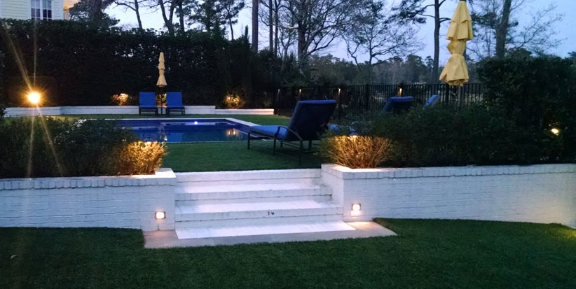 upscale backyard with pool and outdoor lights